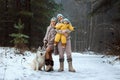 Happy family Dad, mom and baby sy on a winter walk in the forest. Concept for christmas, family, relatives, vacations, fresh air Royalty Free Stock Photo