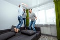 Happy family, Dad, Mom and son spend time together, fooling around on the bed, beating with pillows. Concept of happy father`s da Royalty Free Stock Photo