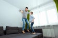 Happy family, Dad and son spend time together, fooling around on the bed, beating with pillows. Concept of happy father`s day, Royalty Free Stock Photo