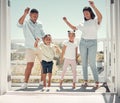 Happy family dancing, couple and kids on balcony of home having fun in celebration of summer life. Mother, father and Royalty Free Stock Photo