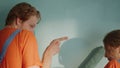 Happy family dancing during decorate wall. Couple painting in new house. Royalty Free Stock Photo