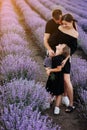 happy family day. Young mother, father and little daughter in purple lavender field. Dad, mom and child hugging and Royalty Free Stock Photo