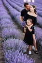 happy family day. Young mother, father and little daughter in purple lavender field. Dad, mom and child hugging and Royalty Free Stock Photo