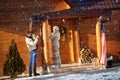 Happy family decorate wooden house for Christmas