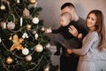 Happy family decorates the Christmas tree. the family is preparing for the new year Royalty Free Stock Photo