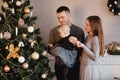 Happy family decorates the Christmas tree. the family is preparing for the new year Royalty Free Stock Photo