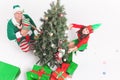 Happy family decorating Christmas tree, dressed in elf costumes Royalty Free Stock Photo