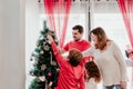 happy family decorating christmas tree at home Royalty Free Stock Photo