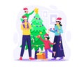 Happy Family decorating a Christmas tree together at Home. Mother, Father, and children preparing for winter holidays Royalty Free Stock Photo