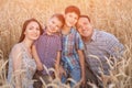 Happy family demonstrates toothy smile on ripe wheat field Royalty Free Stock Photo