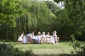 Happy Family Dining Together In Garden