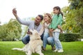 Happy family with dog taking selfie by smartphone Royalty Free Stock Photo