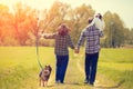 Happy family with dog walking on the rural road Royalty Free Stock Photo