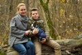 Happy family with a dog in the woods. Mom and son on a walk with a pet. Royalty Free Stock Photo