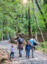 Happy family are doing hiking in the forest