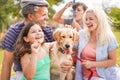 Happy family doing picnic in nature outdoor - Young parents having fun with children and their dog in summer time laughing, Royalty Free Stock Photo