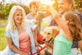 Happy family doing picnic in nature outdoor - Young parents having fun with children and their dog in summer time laughing, Royalty Free Stock Photo