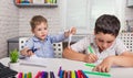 Happy family drawing pictures. Cute boys studying drawing at school. Royalty Free Stock Photo