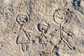 Happy family drawing on sand in the summer Royalty Free Stock Photo