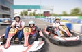 Happy family driving go kart on the track Royalty Free Stock Photo