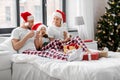 happy family eating coookies in bed on christmas