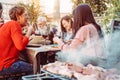 Happy family eating and drinking wine at barbecue dinner in the garden - People with different ages dining together at bbq lunch Royalty Free Stock Photo