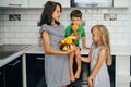 Happy family eating fresh fruit. The concept of healthy eating. funny childs with fruits in the kitchen Royalty Free Stock Photo