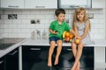 Happy family eating fresh fruit. The concept of healthy eating. funny childs with fruits in the kitchen Royalty Free Stock Photo