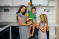 Happy family eating fresh fruit. The concept of healthy eating. funny childs with fruits in the kitchen Royalty Free Stock Photo