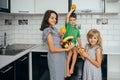 Happy family eating fresh fruit. The concept of healthy eating. funny childs with fruits in the kitchen Royalty Free Stock Photo