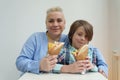 Happy family eating Greek gyros. Portrait of cheerful white woman with short hair and her little son enjoying fast food in a cafe Royalty Free Stock Photo