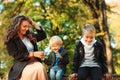 Happy family enjoying autumn. Mother with children walking in autumn park. Autumn vacation Royalty Free Stock Photo