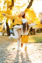 Happy family enjoying the autumn vacation at nature. Stylish family on autumn walk Royalty Free Stock Photo