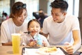 Happy family enjoying dinner in restaurant. Royalty Free Stock Photo