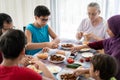 Happy family enjoying eating food in dining room together