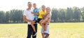 Happy family enjoying life together at meadow outdoor. Royalty Free Stock Photo