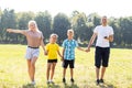 Happy family enjoying life together at meadow outdoor. Royalty Free Stock Photo