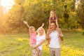 Happy family enjoying life together at meadow outdoor. Royalty Free Stock Photo