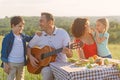 Happy family enjoying lunch outdoors Royalty Free Stock Photo