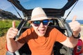 Happy man enjoying road trip and summer vacation. Travel, holidays and people concept Royalty Free Stock Photo