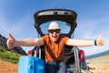 Happy man enjoying road trip and summer vacation. Travel, holidays and people concept Royalty Free Stock Photo