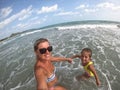 Happy family is enjoying a sunny day at the beach. Mother and daughter Royalty Free Stock Photo