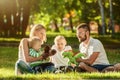 Happy family enjoying sunny day playing in the park Royalty Free Stock Photo