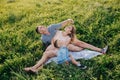 Happy family enjoying together in summer day. Family sitting on grass and embracing Royalty Free Stock Photo