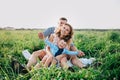 Happy family enjoying together in summer day. Family sitting on grass Royalty Free Stock Photo