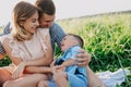 Happy family enjoying together in summer day. Family sitting on grass Royalty Free Stock Photo