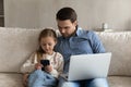 Happy family enjoying using different devices at home. Royalty Free Stock Photo