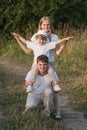 Happy family enjoying walk together at meadow in summer Royalty Free Stock Photo