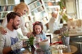 Happy family enjoys planting the plant at home together. Family, leisure, together Royalty Free Stock Photo