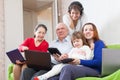 Happy family enjoys with various laptops at home